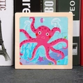 Pink cartoon octopus wooden puzzle for kids featuring marine animals on a square board - Octopus