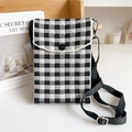 Detailed macro view of black and white checkered knit fabric and adjustable strap - Small Checkerboard Black