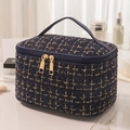 Navy blue tweed makeup bag with gold zipper and woven texture on marble surface - Navy Blue