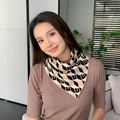 Knitted scarf featuring black, beige and white geometric diamond pattern on model - Cube Black Camel