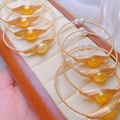 Minimalist gold wire wrapped bracelets featuring large golden pearls and white pearls - Gold Wire Wrapped Pearl Style