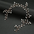 Detailed view of rose gold bridal hairpiece with marquise crystals on black background - Rose Gold