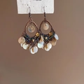 Macro detail of bronze bohemian earrings with shell sequins and colorful beads - Ear Hook Bronze White Shell Pieces