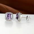Close-up of square purple zircon stud earrings with micro-pave white halo on silver metal - Purple
