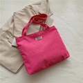 Rose pink corduroy tote bag featuring a central 'FASHION INSTINCT' woven label - Rose Red