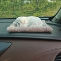 Realistic white plush toy dog on a gray soft mat, placed on a car dashboard detail - Large White Labrador Dog