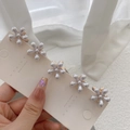 Set of five mini pearl flower hair clips with gold alloy claws on a white card display - 5 Pieces / Pearl White