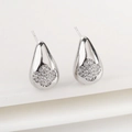 Macro shot of silver teardrop earrings with clover-shaped cubic zirconia inlay - Silver