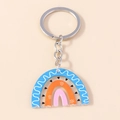 Rainbow acrylic keychain with heart patterns and silver ring on beige background - Blue Rainbow Wave