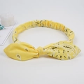 Elastic rabbit ear knot headband featuring yellow paisley print and soft fabric finish - Paisley Yellow