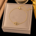Bracelet élégant en acier inoxydable doré avec deux breloques en forme de cœur entrelacés - Bracelet Doré (SLE2135)