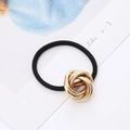 Detail of high-elastic black hair tie featuring a knotted gold metallic multi-ring charm - Gold Six-Ring Circle