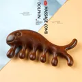 Whale-shaped sandalwood scalp massage comb with natural wood grain on a bicolor background - Golden Silk Sandalwood - Whale Shape