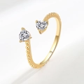 Adjustable gold dual heart ring featuring clear heart-cut stones and beaded band - April (White)