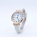 Women's minimalist quartz watch with rose gold case and white dial on display stand - Off White