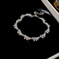 Detalle macro de la pulsera de perlas plateadas con circones brillantes sobre terciopelo - Plateado