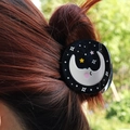 Black moon and stars circular hair claw clip worn on reddish brown hair with outdoor background - Moon Star (H1278)