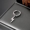 Macro detail of silver stainless steel lightning bolt pendant and hoop earring - Flash