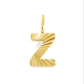 Macro detail of a golden letter Z pendant featuring unique radial sunburst textures - Letter Z - Gold