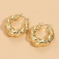 Twisted geometric gold hoop earrings in 14K plated finish on beige background - Twisted (ES2144) / Gold