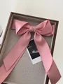 Pink satin oversized bow hair clip with long ribbons on a wooden tray accessory - Korean Pink
