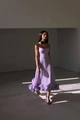 Detail of lavender purple A-line dress featuring tiered ruffled hem and elegant pleats - XS / Purple