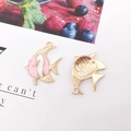 Detailed view of pink and white enamel goldfish charms with gold metal alloy base - Pink Tropical Fish (23x27mm)