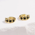 Golden hoop earrings with black star enamel charms on a white stone background - Five-pointed Star Black