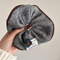 Grey knitted polka dot scrunchie featuring a blue crochet flower and fabric label - Knit Flower Patch Grey Scrunchie