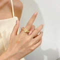 Golden heart ring with pale gemstone and delicate wing accents on finger - 14K Gold Heart Wing Ring (A-1324) / Light Skin