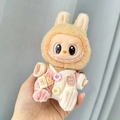 Labubu plush doll wearing brown rabbit hat and pink white knit jumpsuit with heart button - Pink Ribbed Romper / First And Second Generation Keychains Are Compatible With La Cloth Dolls. Dolls Not Included.