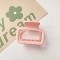 Detail of pink matte rectangular hair claw clip with cutout design on a white background - Matte Small Square Orange