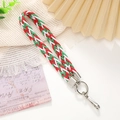 Colorful braided wrist strap with silver metal clasp on a minimalist aesthetic background - White Red Green