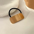 Elegant black elastic hair tie with a minimalist brushed gold rectangular metal charm - Gold