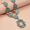 Detailed macro of vintage turquoise statement necklace with carved antique gold and rhinestones - Necklace-Blue