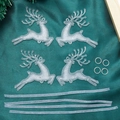 Flat lay of transparent acrylic reindeer Christmas ornaments on a dark green fabric background - Crystal Bead Reindeer 8CM