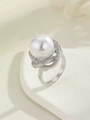 Detail of a white pearl ring featuring cubic zirconia micro-pave in a floral setting - Adjustable Open / Silver Wrapped Pearl Ring