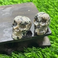 Polished 2.8cm natural stone mini crystal skull with grey and beige speckled texture - Roadside Stone