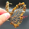 Detailed macro shot of a butterfly hair claw with natural brown and orange crystals - Tiger Eye Gold Butterfly