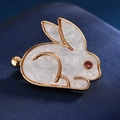 Elegant gold-plated rabbit brooch with white inlay and red crystal eye on blue silk - Red Eye Rabbit