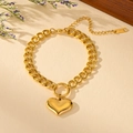 Detail of gold stainless steel link bracelet featuring a solid heart charm and S.STEEL tag - Gold Mirror Heart