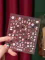 Stickers ongles Noël dorés avec motifs Père Noël, bonhomme de neige et cerf, modèle Aha!071 - Autocollant à Ongles de Noël Aha-071