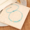 Handgefertigtes Boho-Perlenarmband mit himmelblauer Kordel und natürlichen Türkis-Akzenten - See-Blau (Türkis)