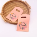 Pink floral mini plastic gift bag with die-cut handles for jewelry packaging in a woven basket - No. 95 (Pink Fashion Floral)
