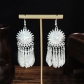 Ethnic style silver tassel earrings with sunburst design on a display stand - Sunflower Hollow Leaf Tassel Style (E2846-18)