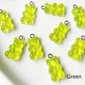 Detailed view of green resin gummy bear pendants with silver metal rings for DIY jewelry - Green