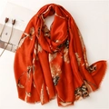 Detail of soft orange linen-feel scarf with gold floral foil print and frayed edges - Orange