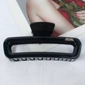 Glossy black square leopard hair claw clip with gold lettering on white fabric - Glossy Black Gold Label