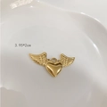 Macro shot of gold-plated titanium heart pendant with wings and size info 3.95x2cm - E20 Angel Wings Heart