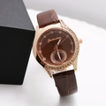 Women's rose gold watch with rhinestone bezel and brown leather strap in 45-degree view - Coffee